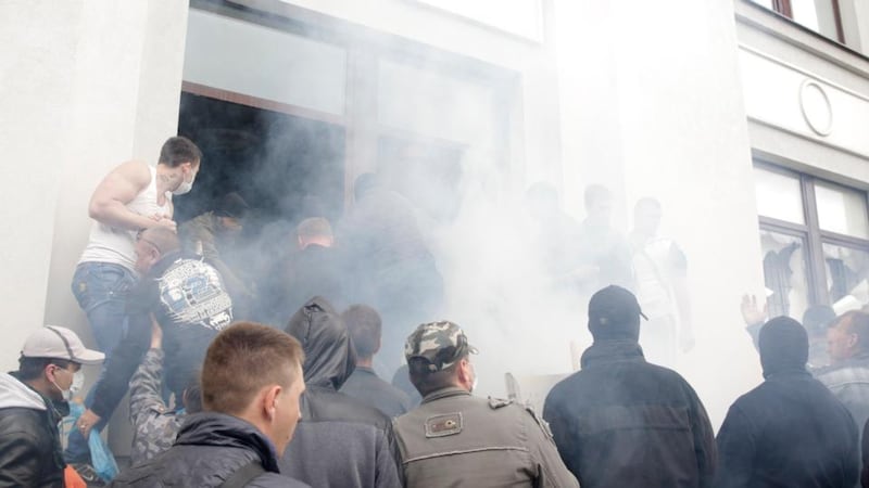 Pro-Russian activists storm the regional government headquarters in Luhansk, eastern Ukraine. Hundreds of pro-Russian separatists stormed the headquarters today, gaining access by breaking windows and facing no resistance from police. Photograph: Vasily Fedosenko/Reuters