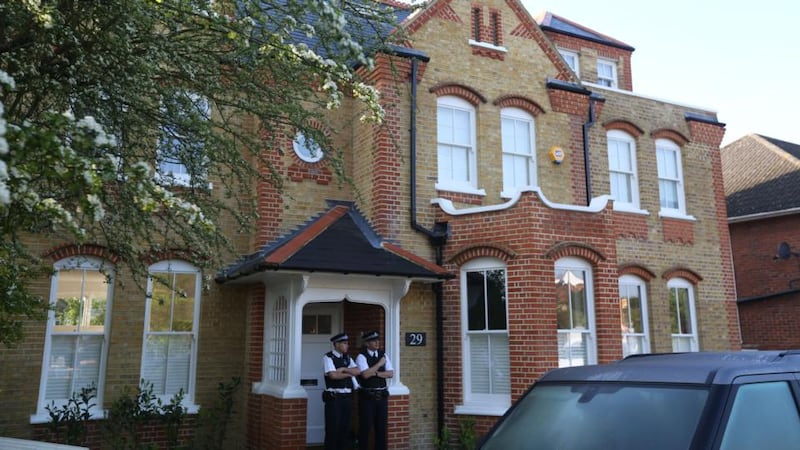 Police at the London house where a   woman was arrested after the discovery of three dead children. Photograph: PA