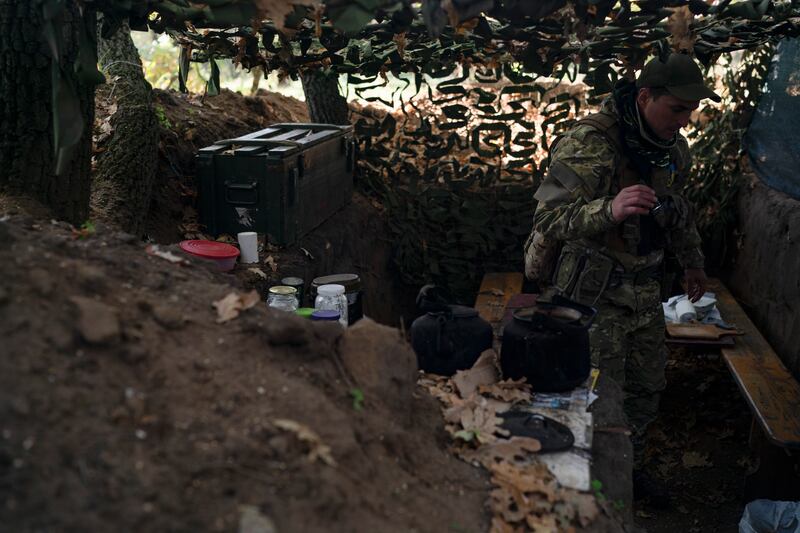 A Ukrainian serviceman checks the trenches dug by Russian soldiers in a retaken area in Kherson region. Photograph: Leo Correa/AP